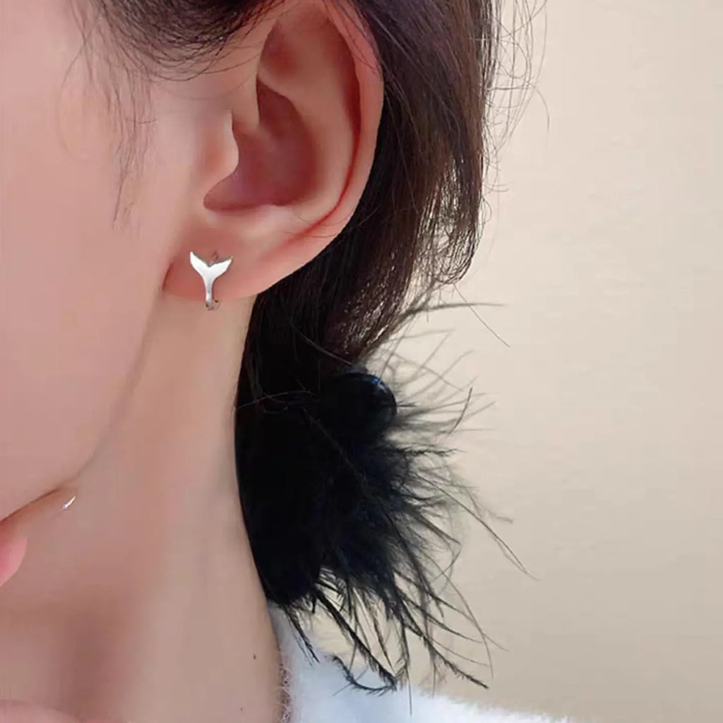 Women's fishtail design earrings with gold electroplating on copper, showing white gold and yellow gold colour options