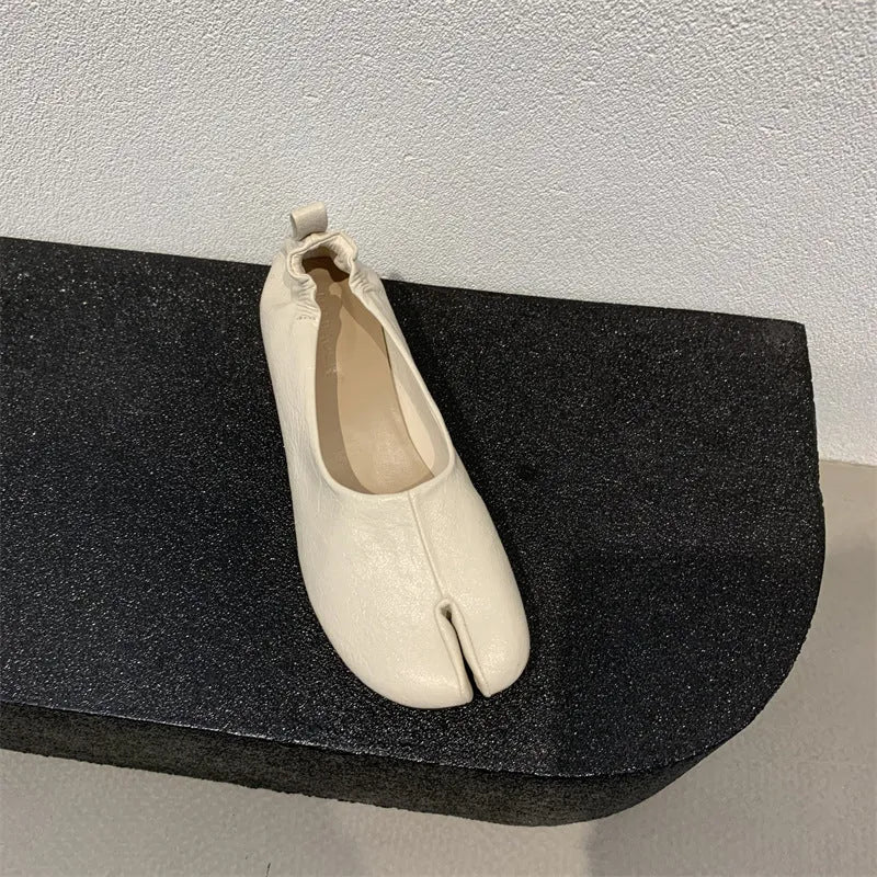 Women's black split toe chunky heel pumps with a round toe and low heel on a rubber sole.