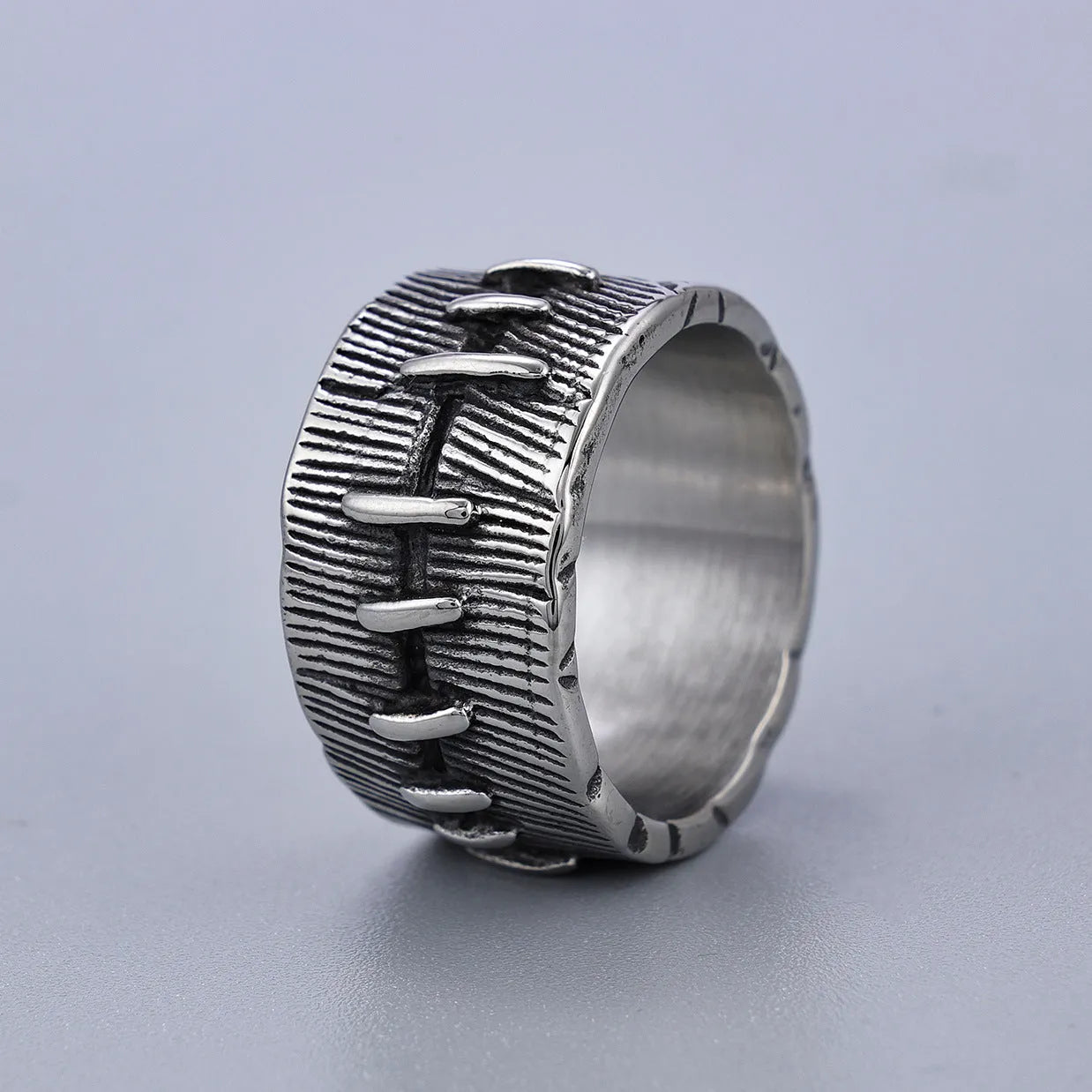 Titanium steel geometric double ring with U-shape, stitched pattern, and retro dark colour