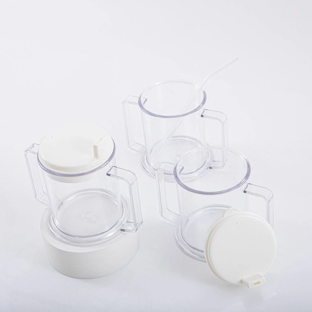 Transparent plastic spill-proof drinking cup on a table.