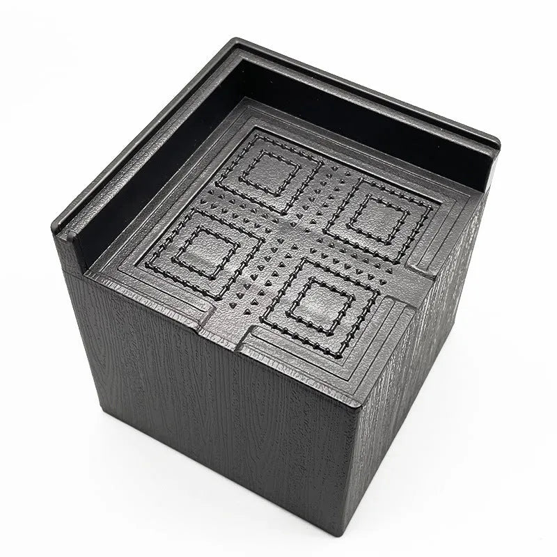 Four black plastic furniture foot mats for bed or sofa height adjustment.