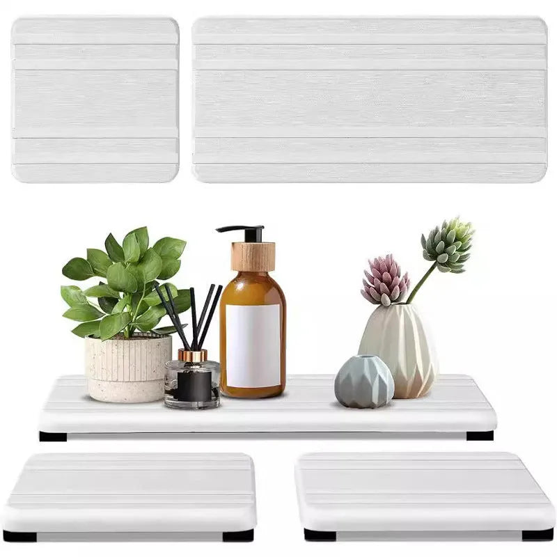 Three square diatom oil bathroom countertop drying mats in solid colours on a bathroom vanity