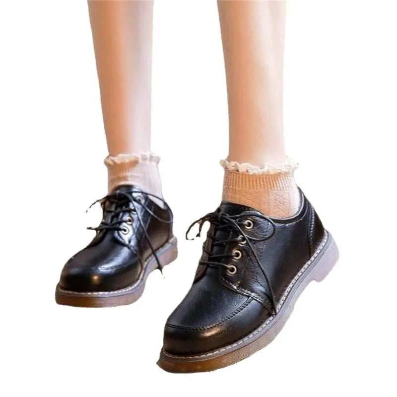 Women's black retro preppy Mary Jane shoes with front lace-up and low square heel on a white background