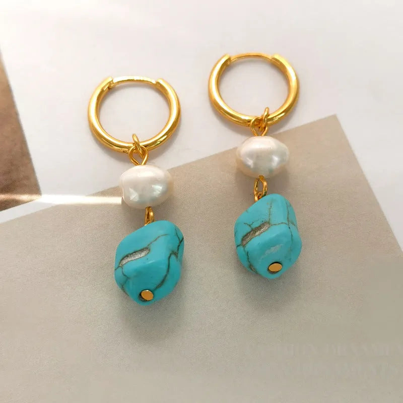A pair of geometric copper earrings with irregular turquoise stones and cultured pearls
