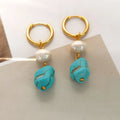 A pair of geometric copper earrings with irregular turquoise stones and cultured pearls