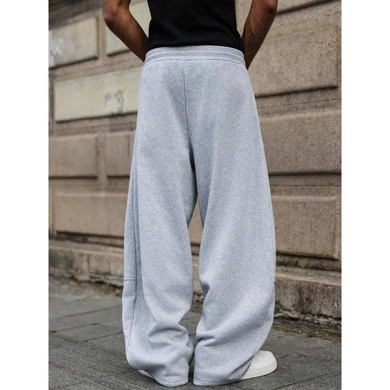 Men's straight-leg high-waist trousers in a grey colour, showcasing the cropped length and casual style.