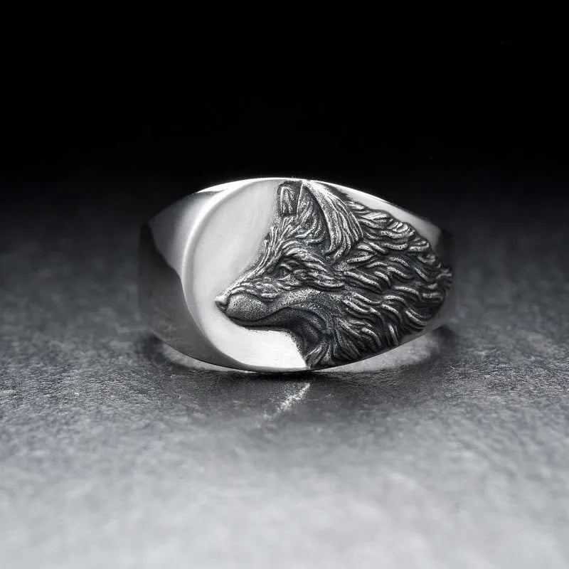 Men's geometric wolf head alloy ring in silver colour on a size guide showing UK sizes 6 to 12.