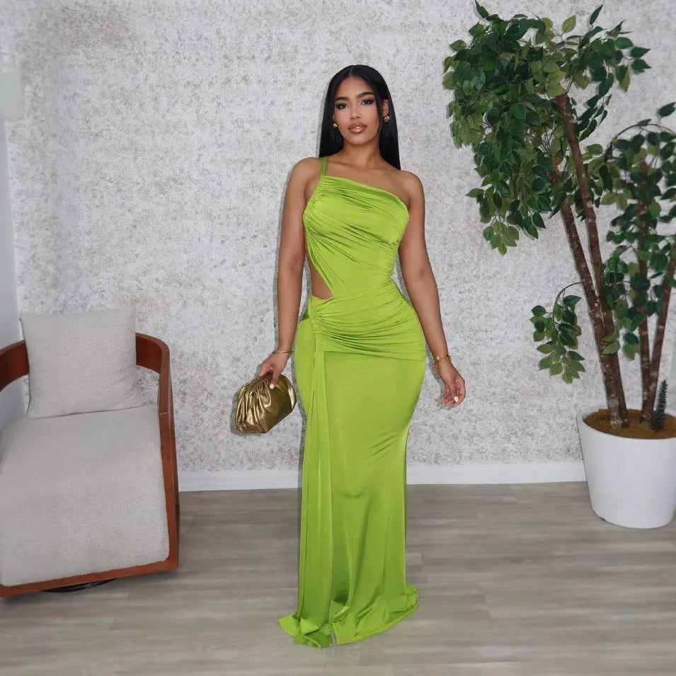 Women's solid colour long dress with one shoulder strap and pleated skirt in white, orange, or green.