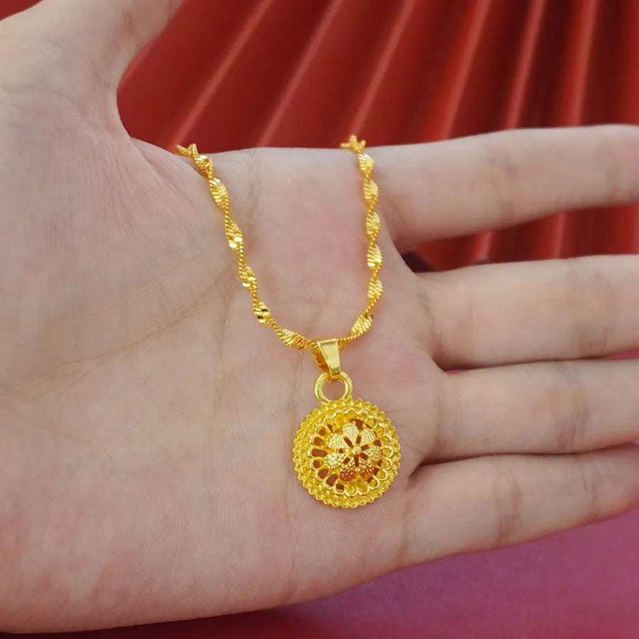 Gold plated three-piece jewellery set with floral pendant, matching earrings and ring