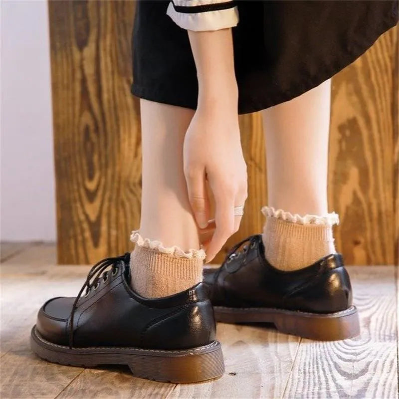 Women's black retro preppy Mary Jane shoes with front lace-up and low square heel on a white background