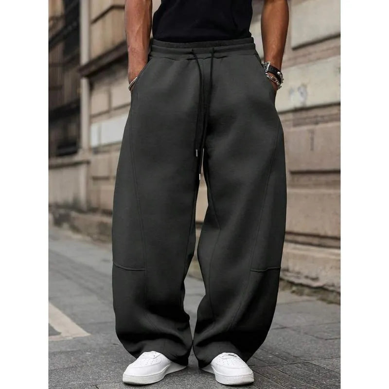 Men's straight-leg high-waist trousers in a grey colour, showcasing the cropped length and casual style.