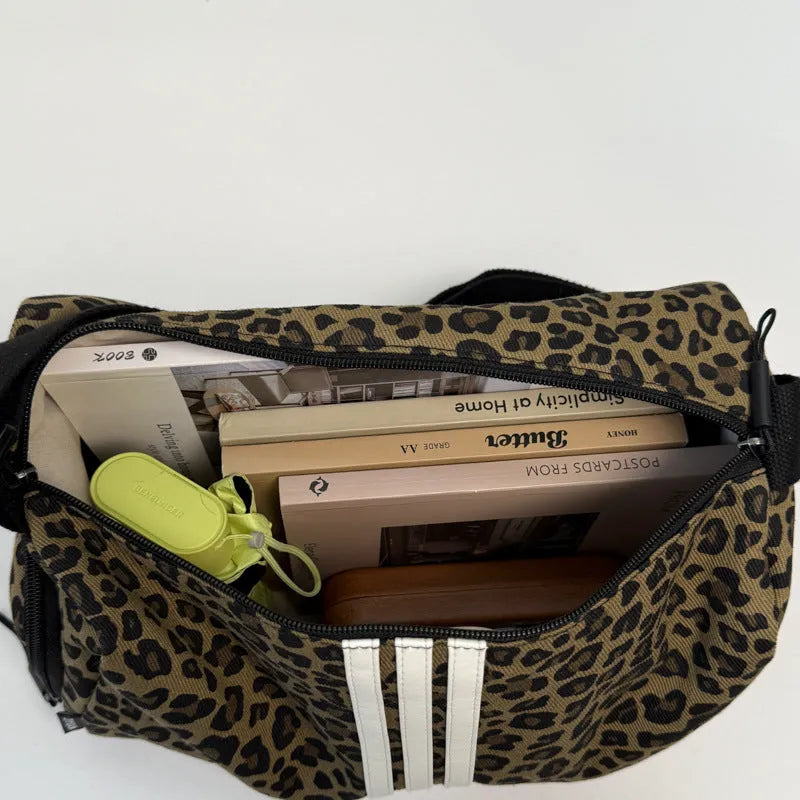 Large leopard print cross-body messenger bag with sports style shoulder strap