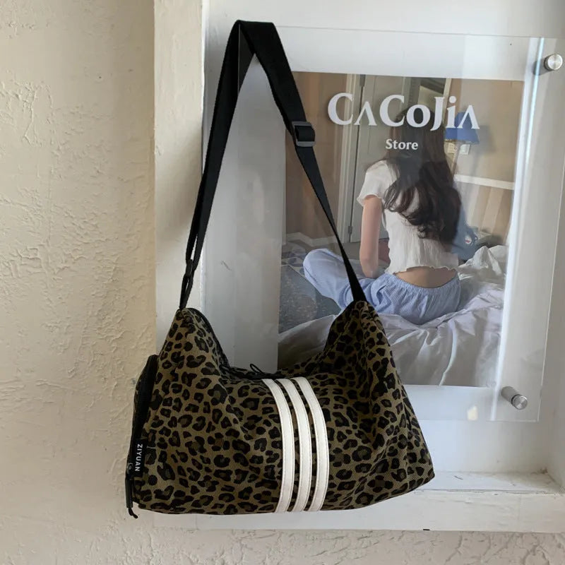 Large leopard print cross-body messenger bag with sports style shoulder strap