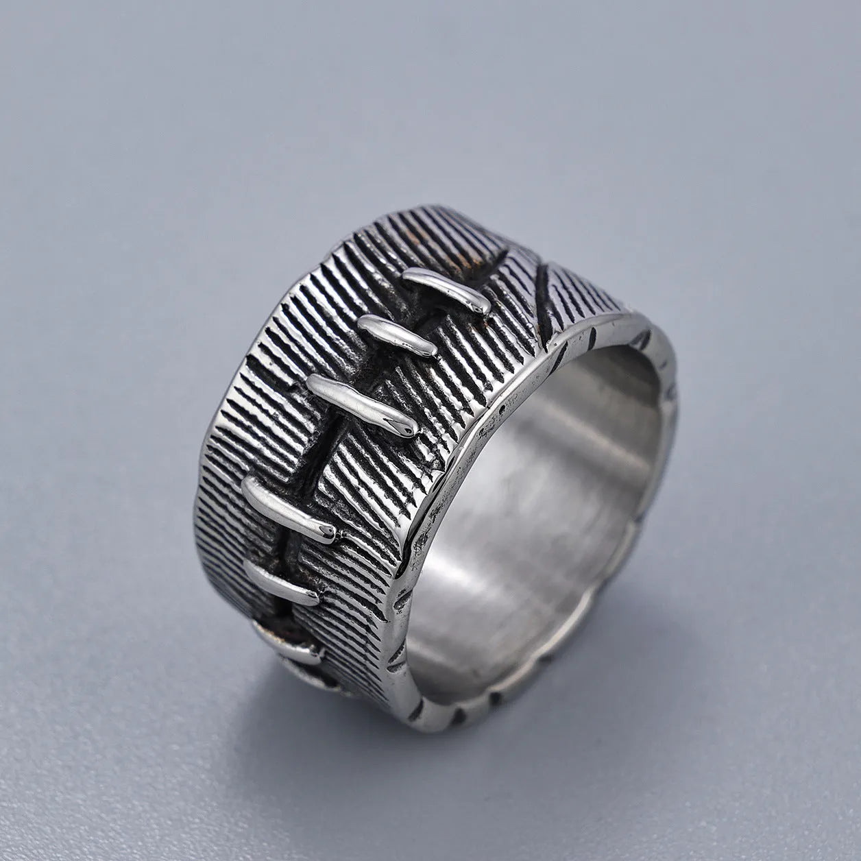 Titanium steel geometric double ring with U-shape, stitched pattern, and retro dark colour