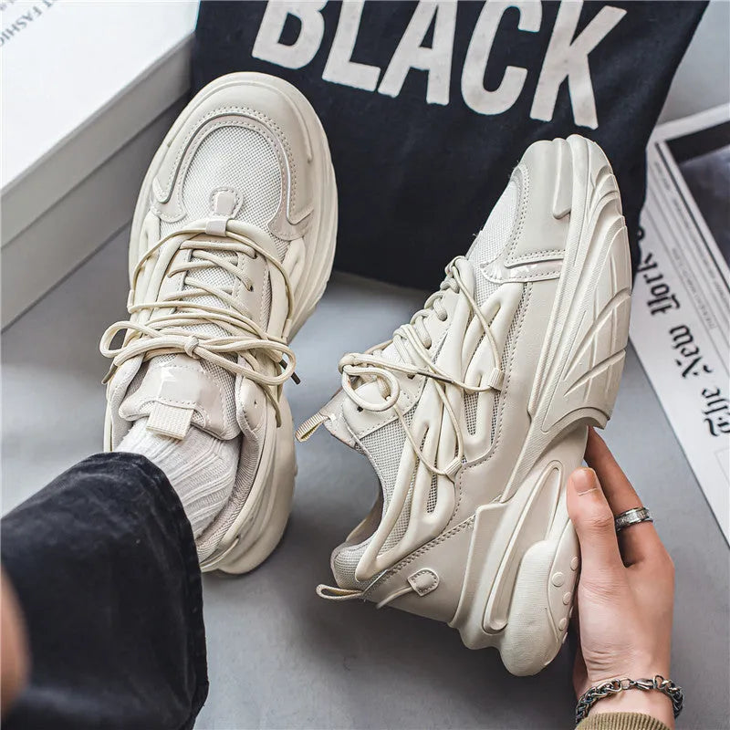 Men's beige low-top lace-up sneaker with mesh upper and platform rubber sole.
