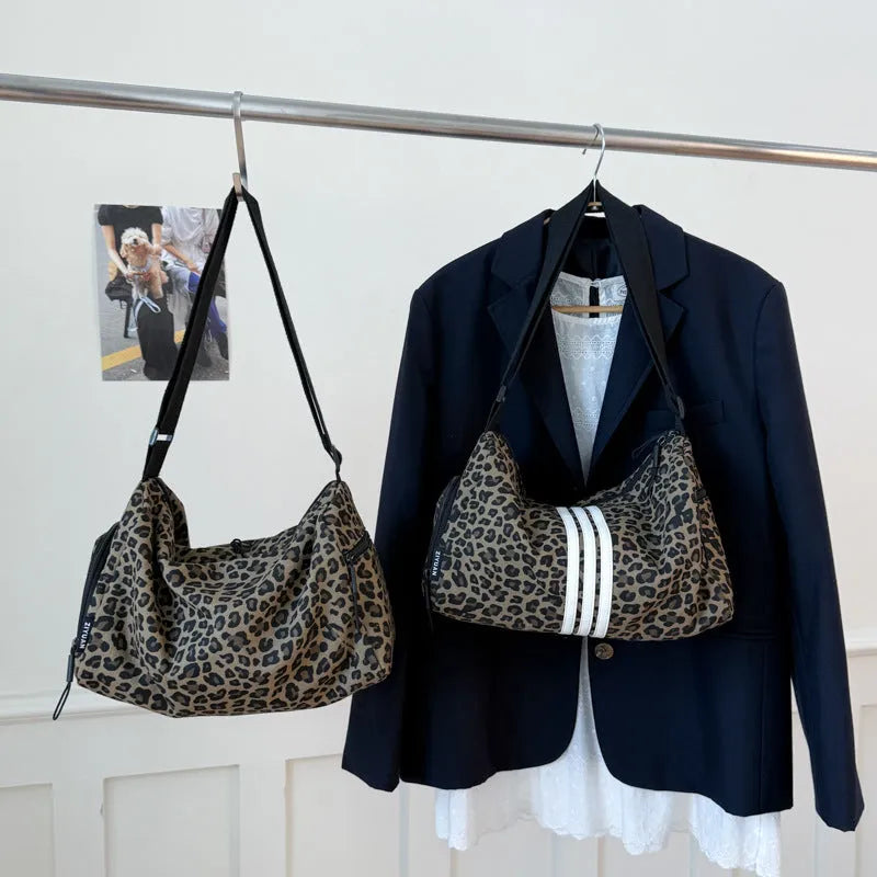 Large leopard print cross-body messenger bag with sports style shoulder strap