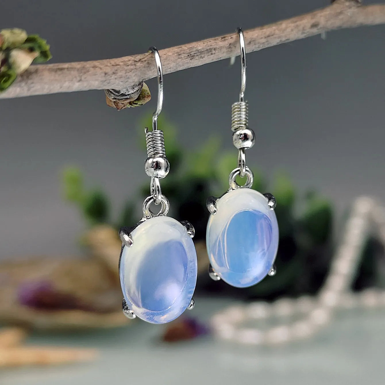 Moonlight opal drop earrings with retro cross design and ellipse detailing
