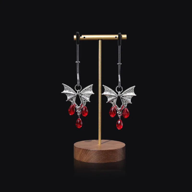 Silver bat-shaped nipple clamps with ruby accents and adjustable pressure mechanism