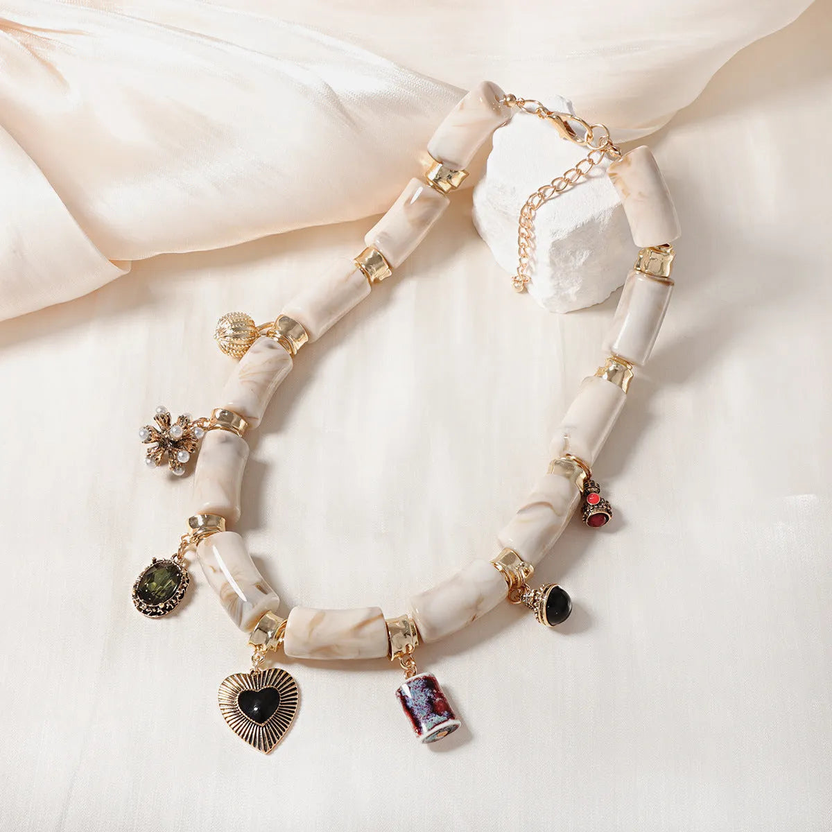 Heart-shaped bamboo design resin necklace with electroplated picture colour finish on a chain.