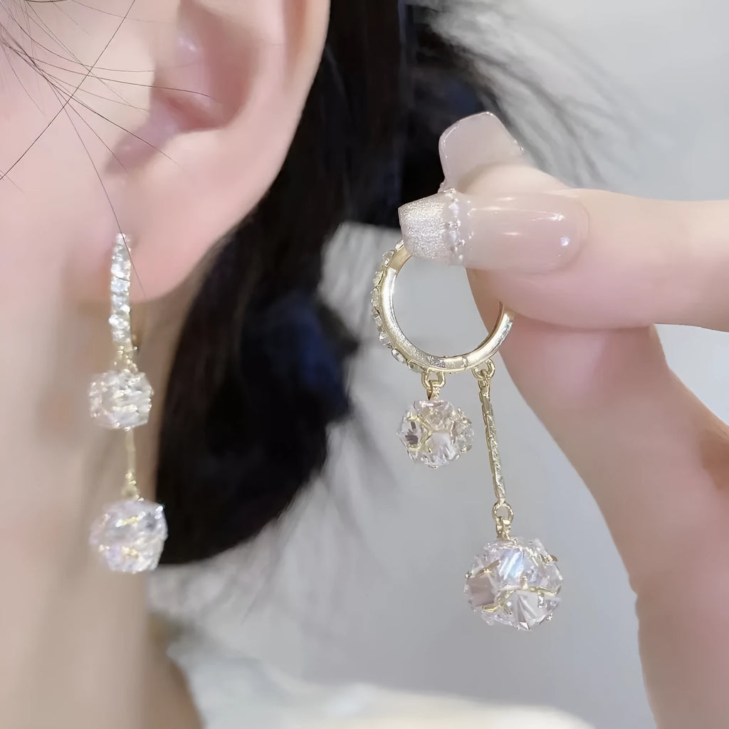 Silver tassel ball earrings with confession balloon pendant and rhinestone details on ear clips