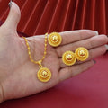 Gold plated three-piece jewellery set with floral pendant, matching earrings and ring
