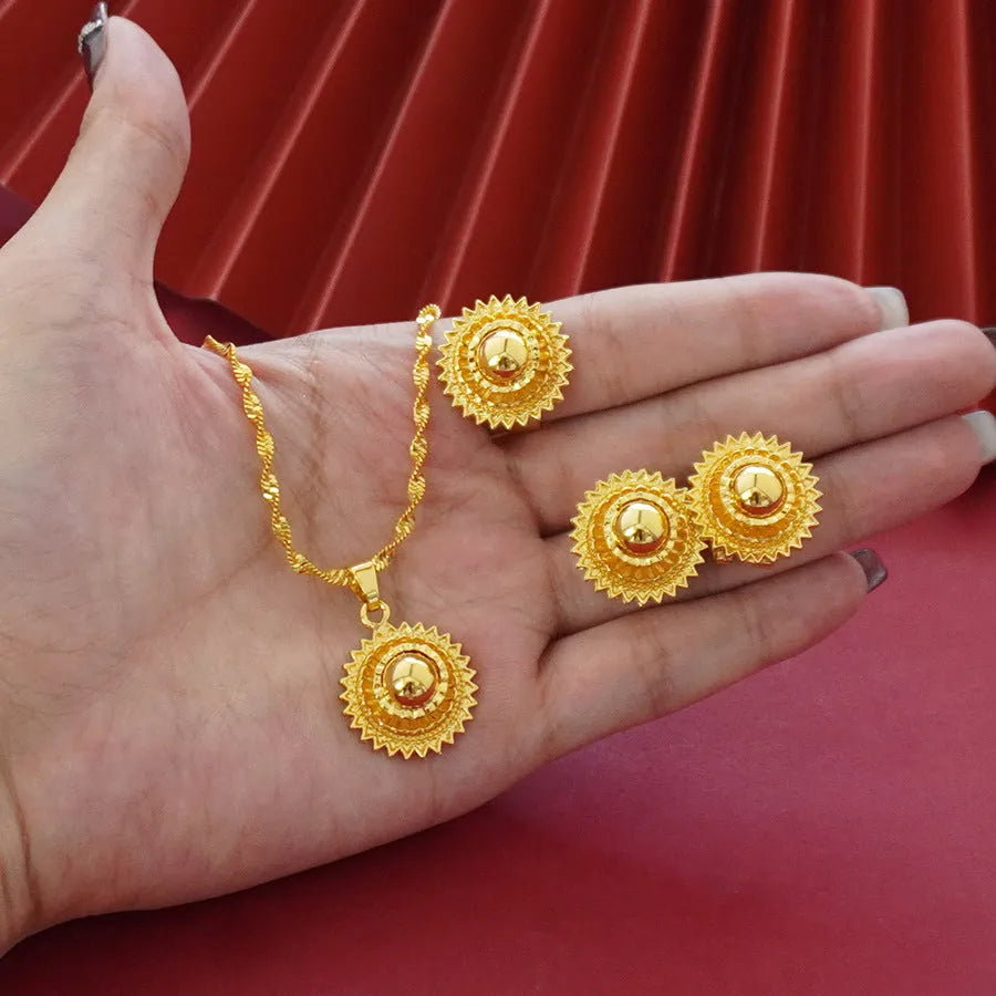 Gold plated three-piece jewellery set with floral pendant, matching earrings and ring