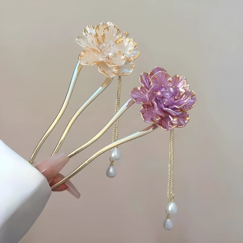 Close-up of a purple U-shaped alloy hairpin with a peony flower and tassel decoration.