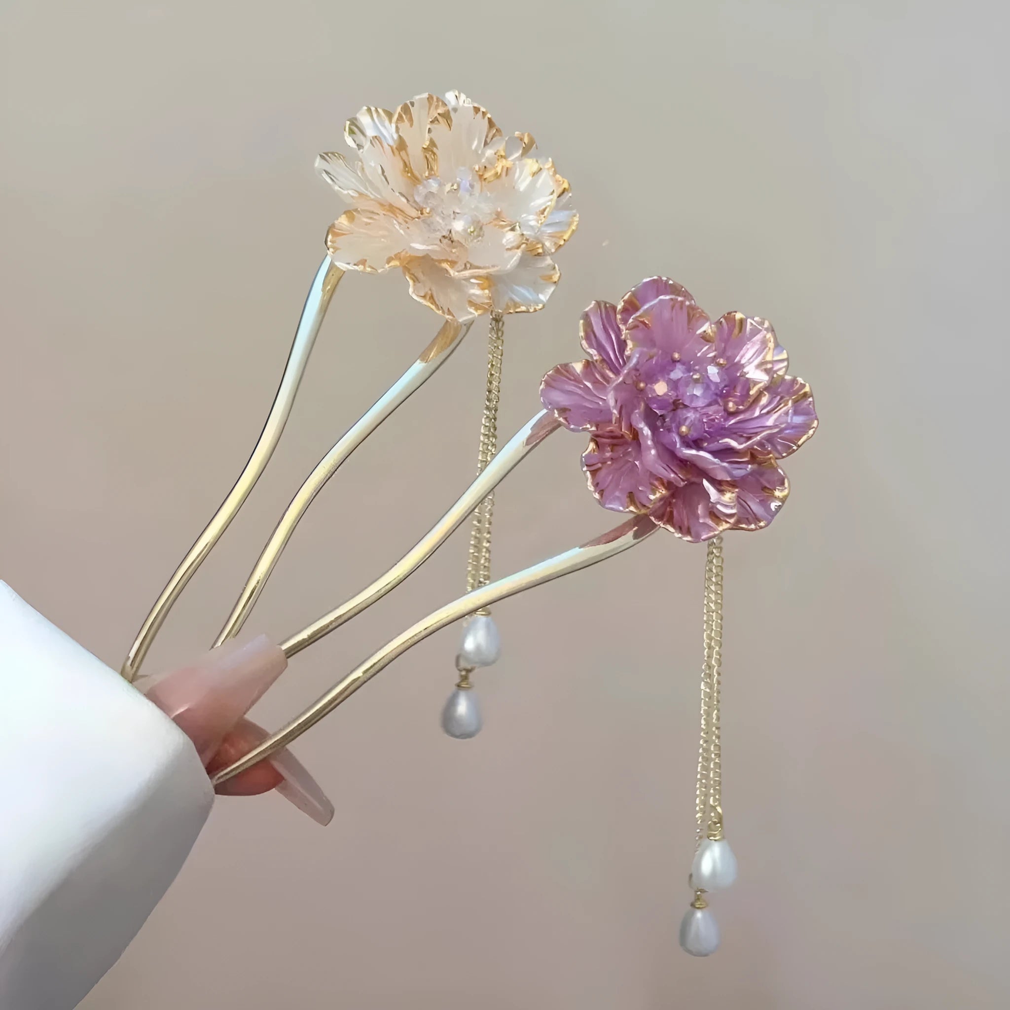 Close-up of a purple U-shaped alloy hairpin with a peony flower and tassel decoration.