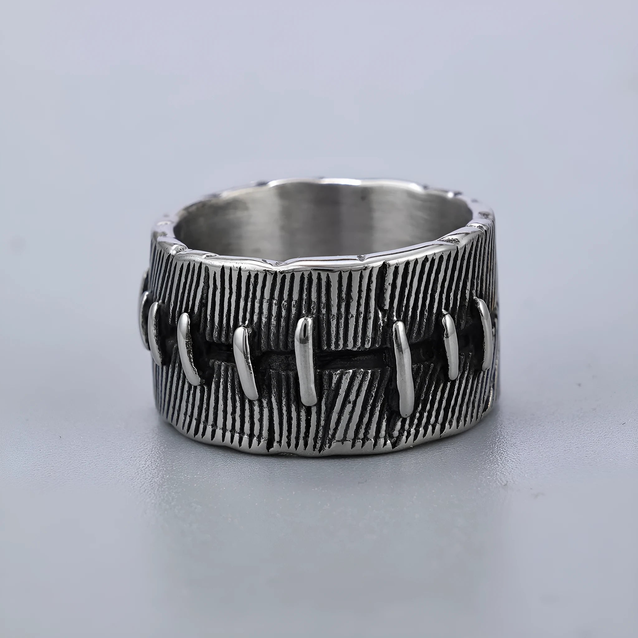 Titanium steel geometric double ring with U-shape, stitched pattern, and retro dark colour