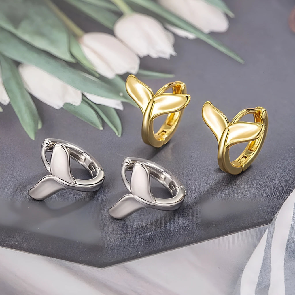 Women's fishtail design earrings with gold electroplating on copper, showing white gold and yellow gold colour options