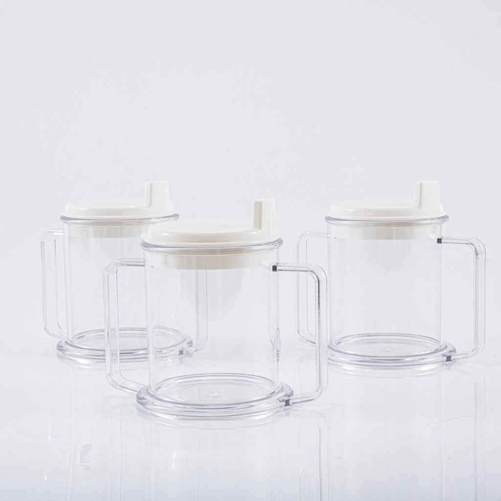Transparent plastic spill-proof drinking cup on a table.