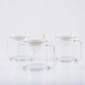 Transparent plastic spill-proof drinking cup on a table.