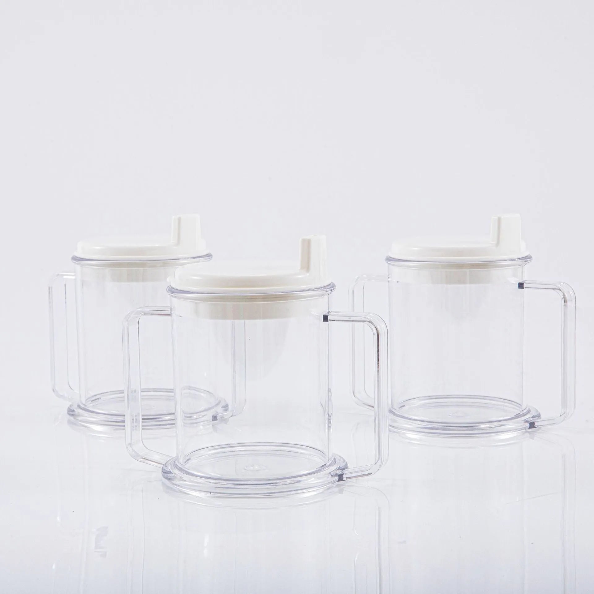 Transparent plastic spill-proof drinking cup on a table.