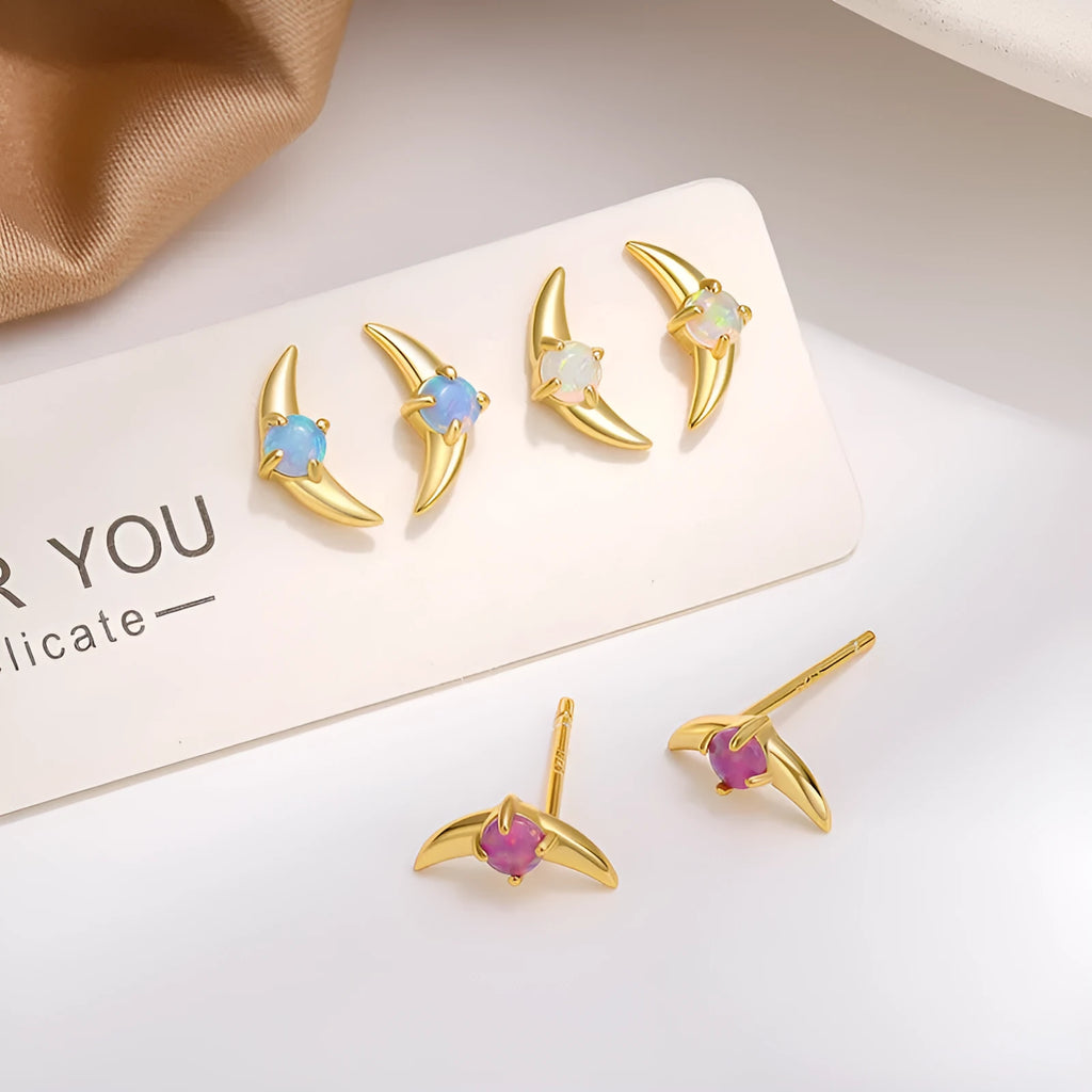 A pair of geometric-shaped sterling silver earrings with a gold-plated finish and a central blue zirconia stone.