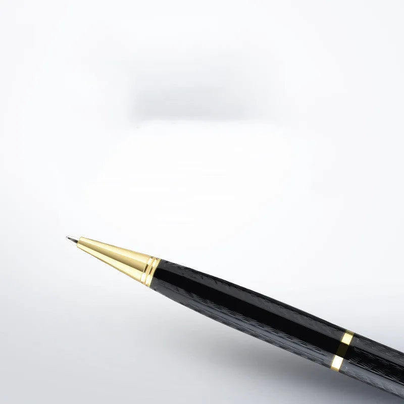 Black pen-shaped digital voice recorder with zinc alloy shell next to included headset and data cable.