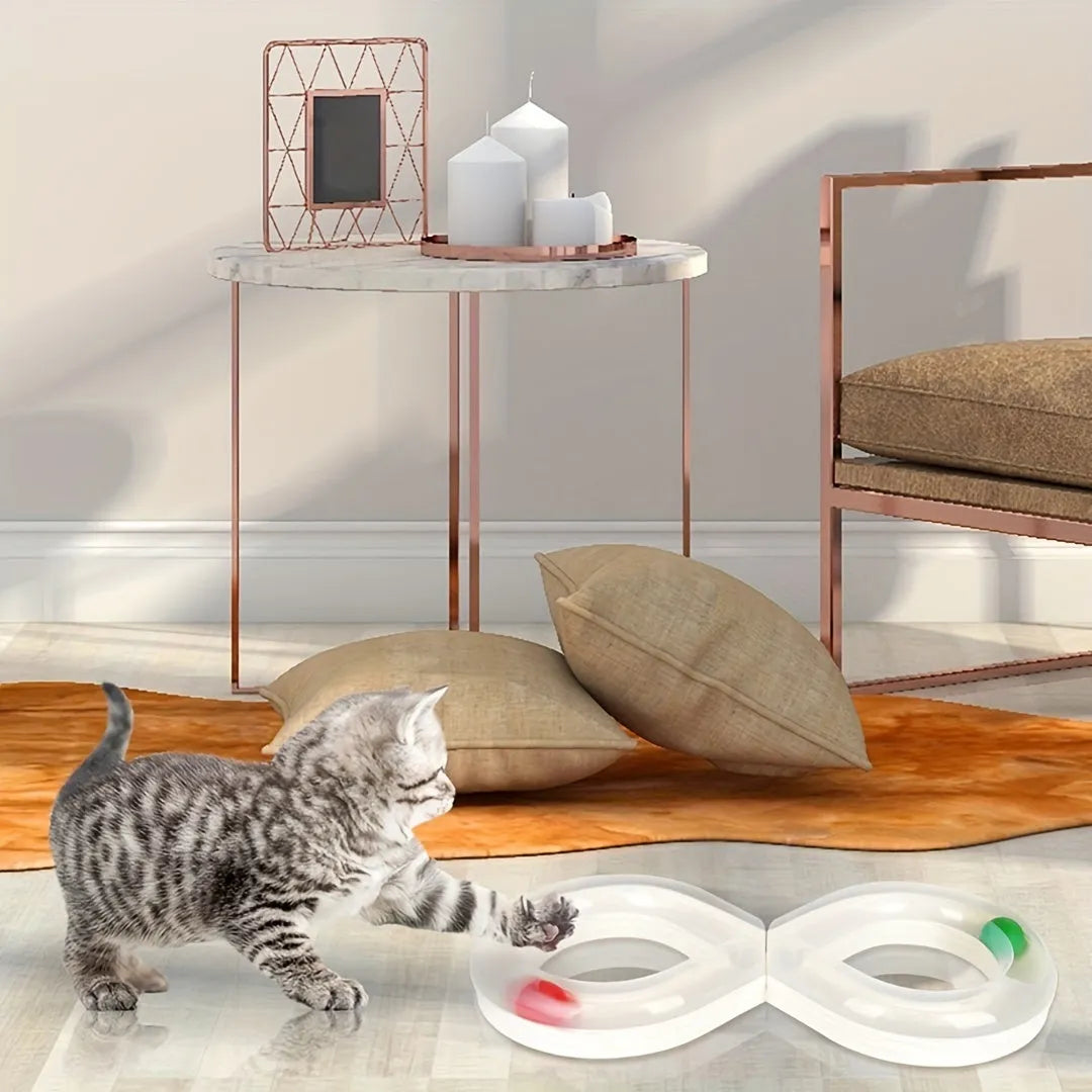 Blue and white cat turntable track ball toy with teasing stick attachment on flat surface