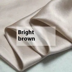Solid colour silk duvet cover shown in Lotus Pink, laid flat on a bed.