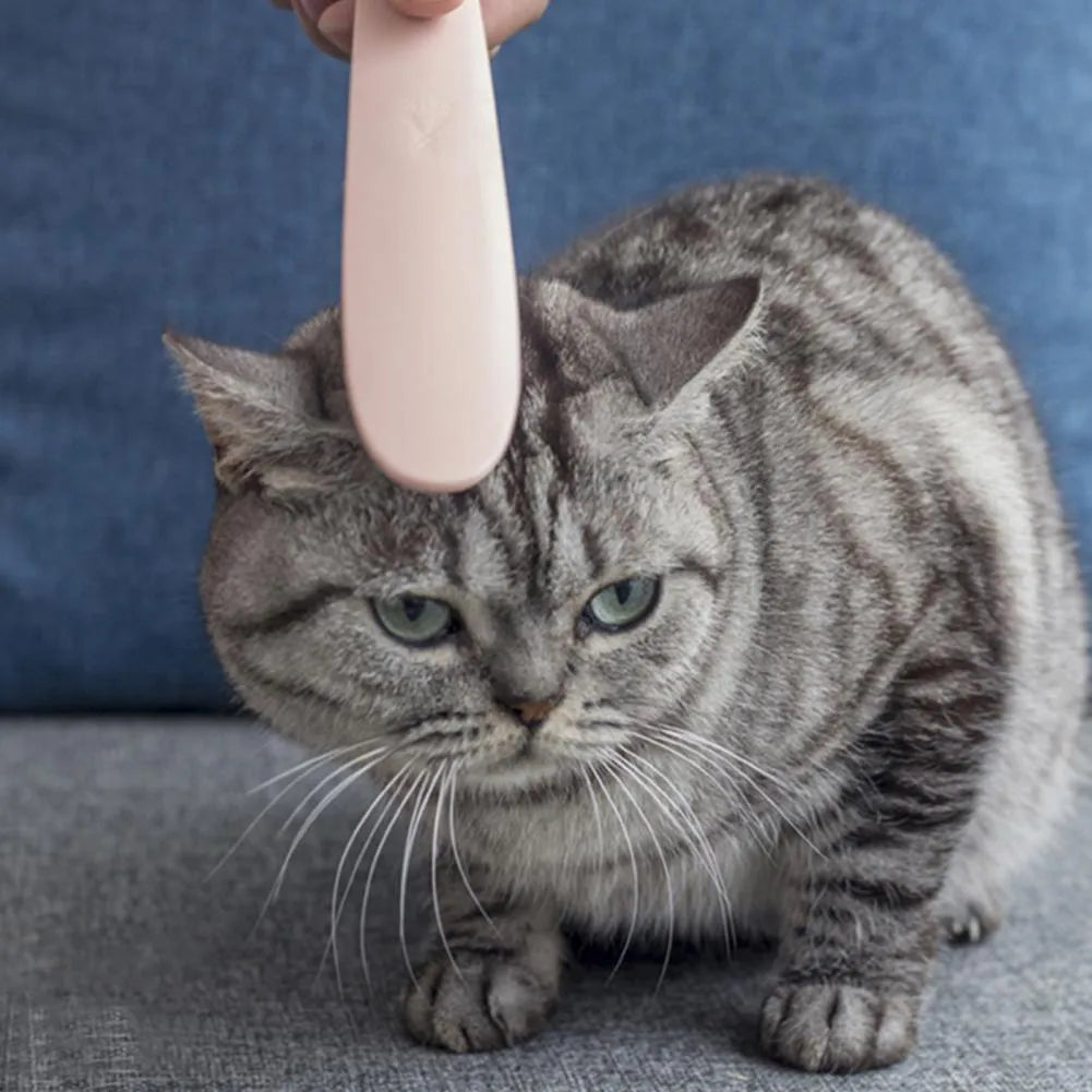 Grey and pink ABS cat grooming comb with tongue massage design and dual-ended grooming surfaces