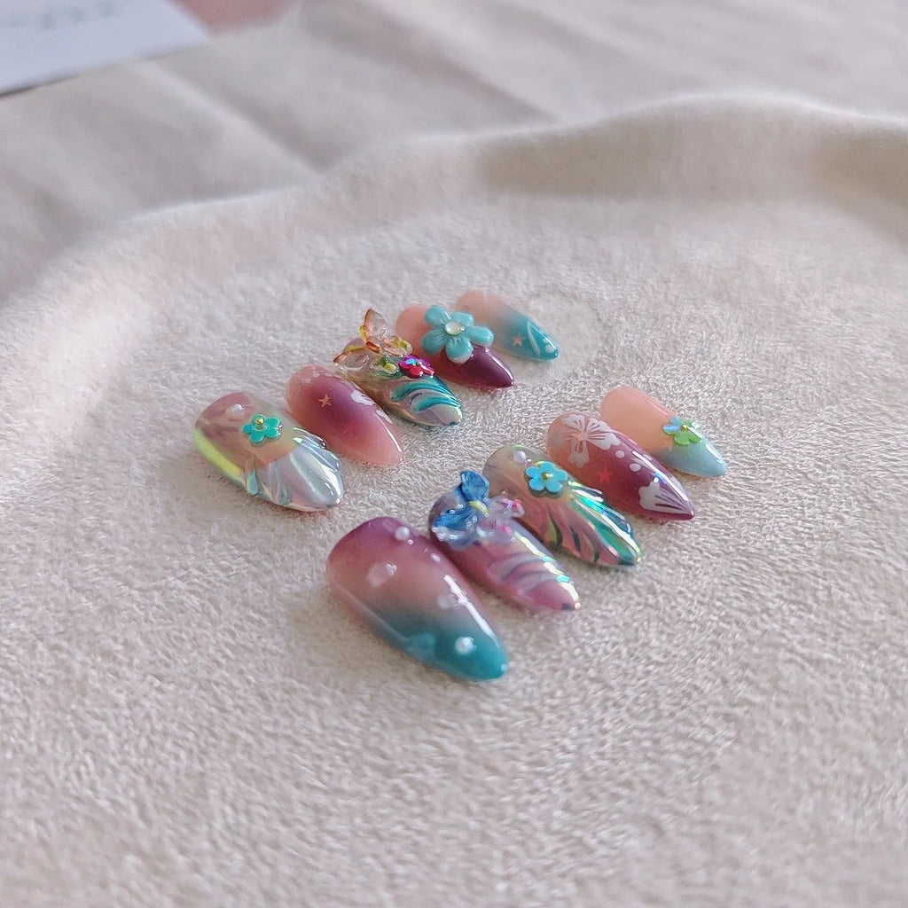 Handmade sculpture manicure set with colourful embossed flower and butterfly patterns on almond shaped nails
