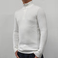 Man wearing a grey zip-up half-turtleneck sweater with long sleeves.