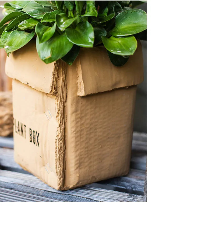 Nordic-style cement brown paper box flowerpot for indoor planting on a floor.