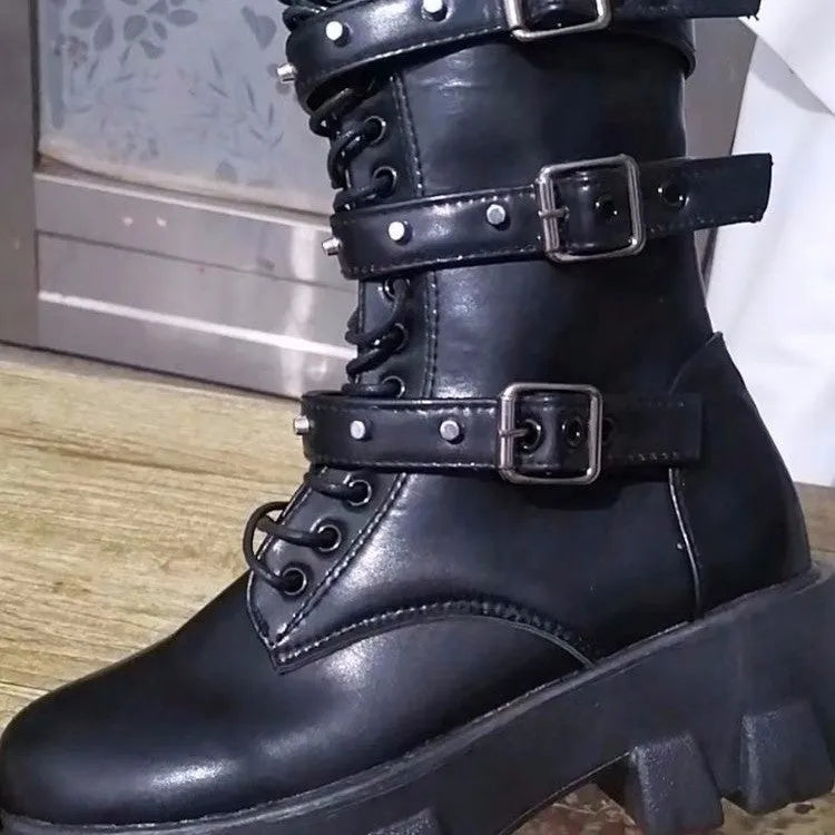 Women's black mid-calf knight boots with a large metal buckle and side zip fastening