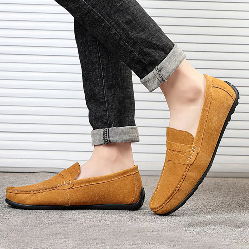 Men's solid colour suede leather slip-on loafers with round toe and flat rubber sole.