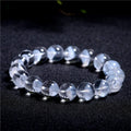 Women's white crystal ghost pyramid bracelet with Ruyi design elements on a wrist.