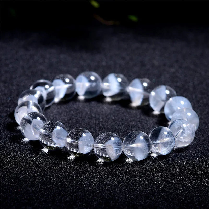 Women's white crystal ghost pyramid bracelet with Ruyi design elements on a wrist.
