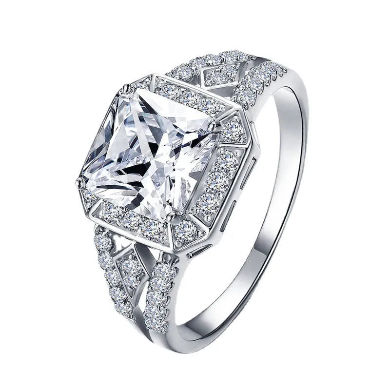Geometric zircon ring with hollow design in platinum colour on copper, showing quadrilateral pattern and inlaid detailing