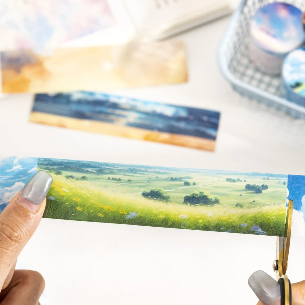 Japanese paper washi tape roll with sky theme designs including clouds, sun, twilight, moon, and nebula