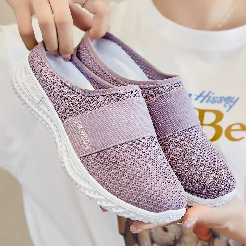 Women's flat casual shoes with mesh upper and hollow-out design in black, grey, pink, or purple.