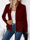 Women's loose black coat with heavy-duty zipper and ruffled hem, shown on a hanger