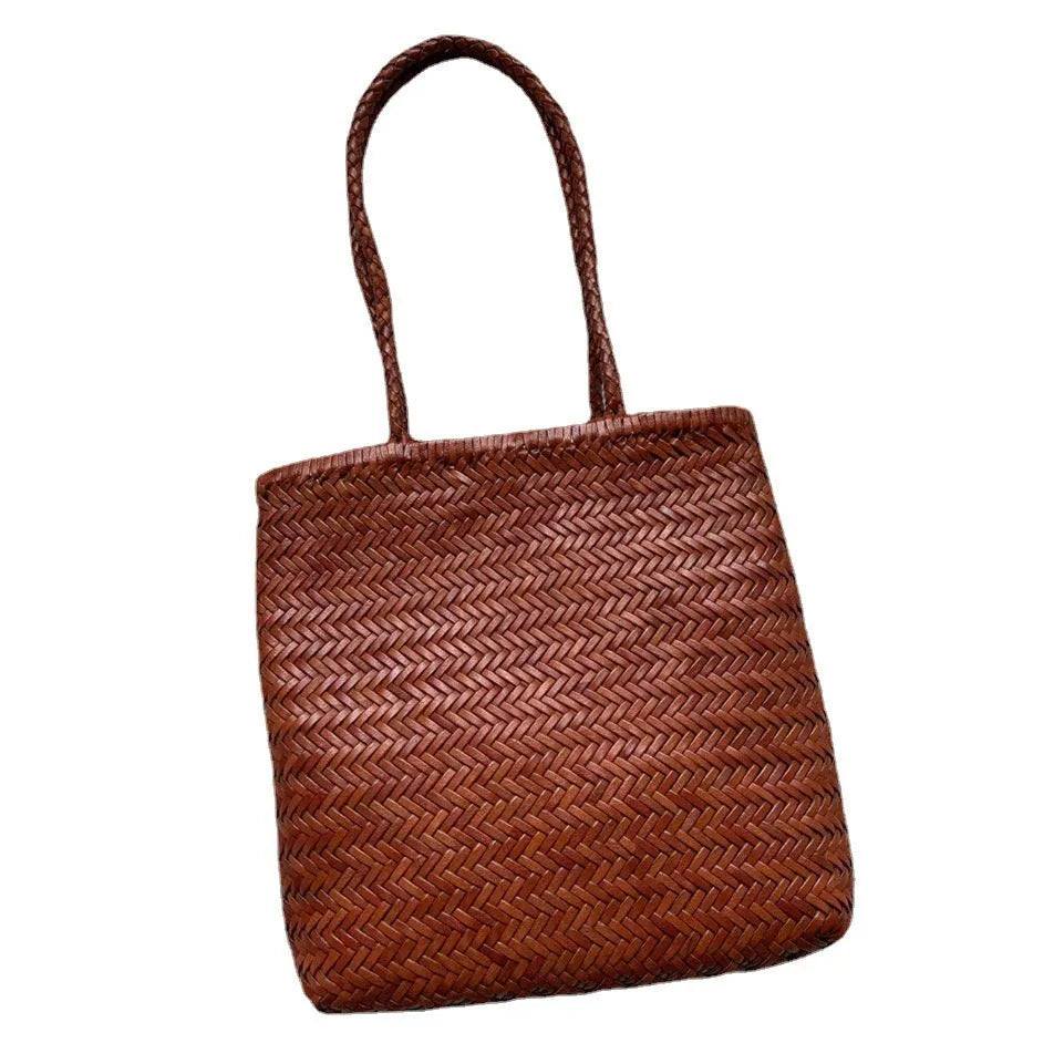 Brown woven leather tote bag with three-dimensional outer pocket and genuine cowhide construction
